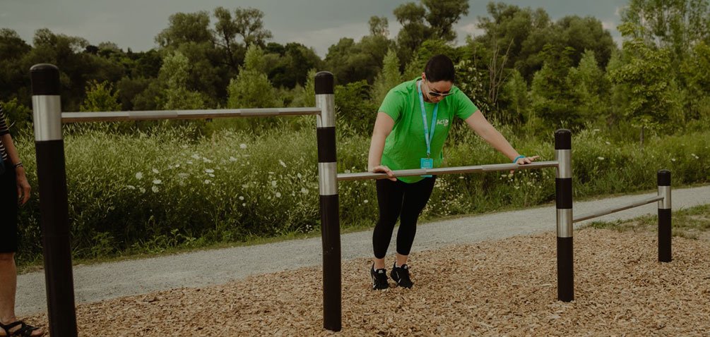staff person demonstrating outdoor fitness technique